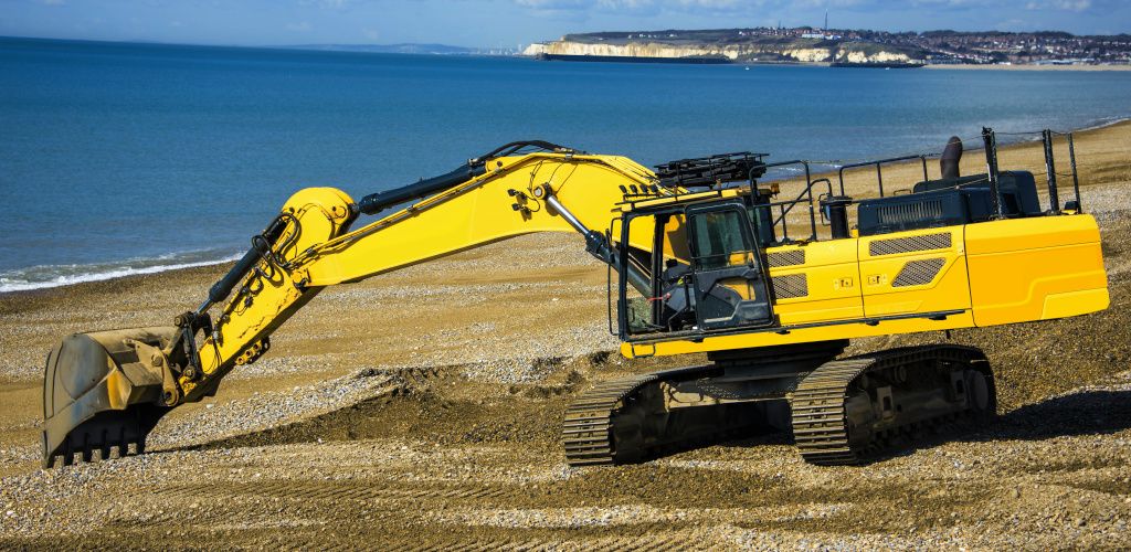 digger on a beach turning